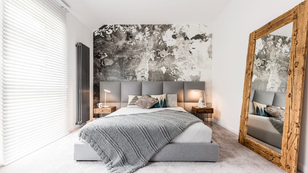 Wallpaper accent wall in shades of gray in a bedroom