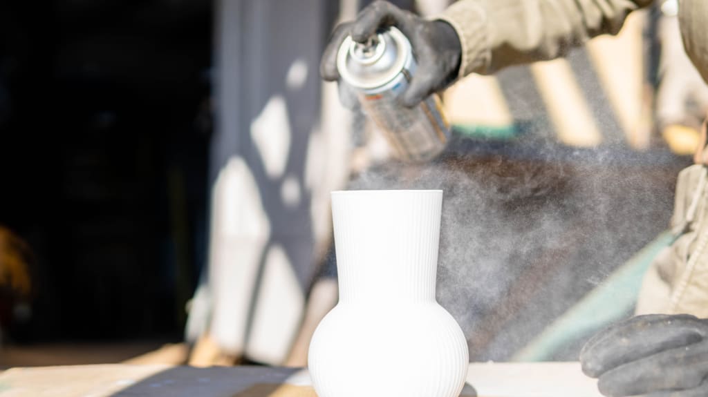Spray paint on white pot