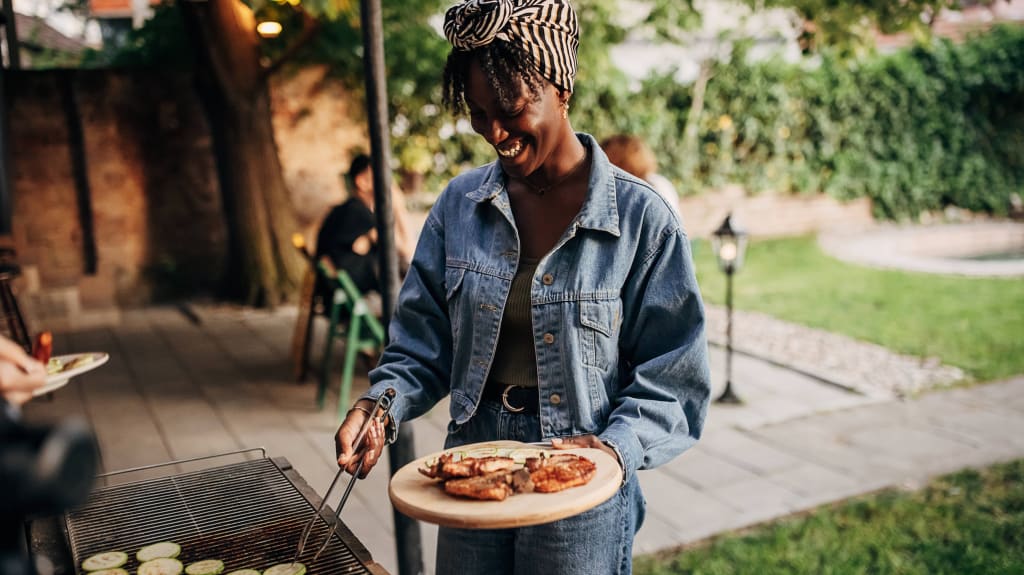 Woman grilling veggies on a BBQ