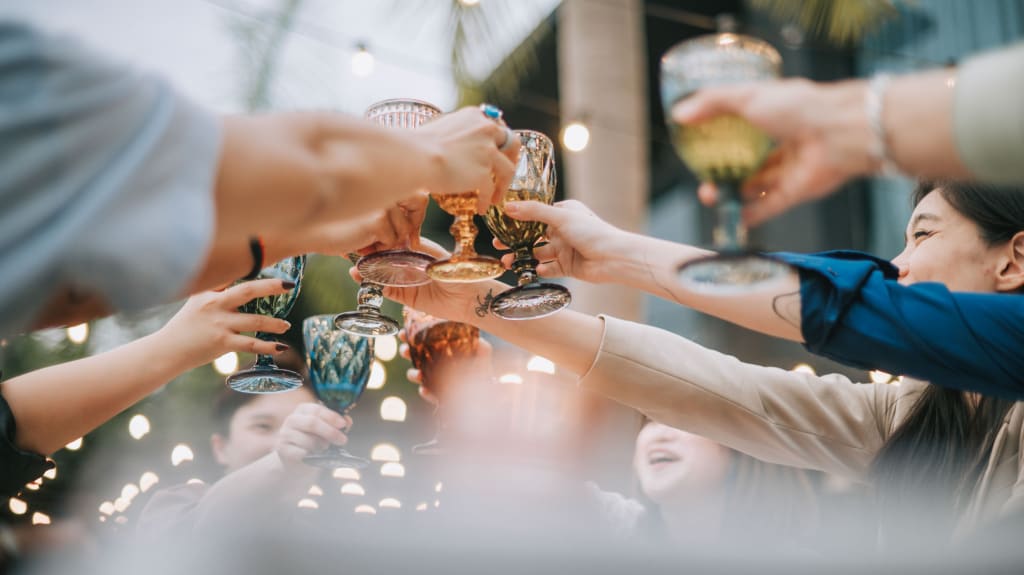 Close-up of friends toasting in celebration