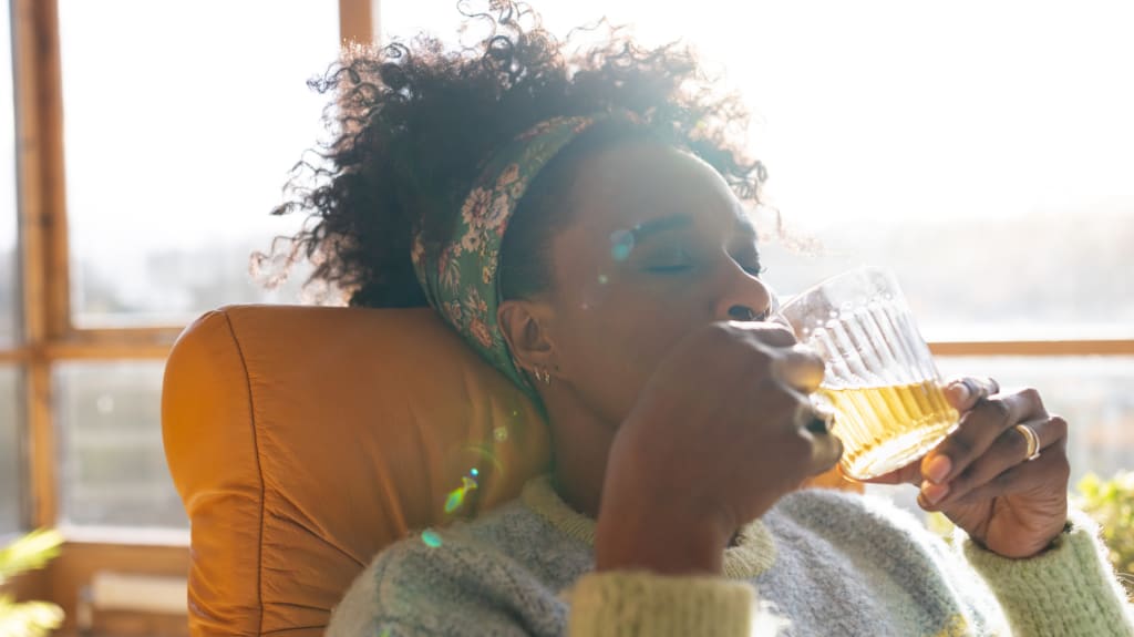 Relaxing with a cup of tea on a sofa