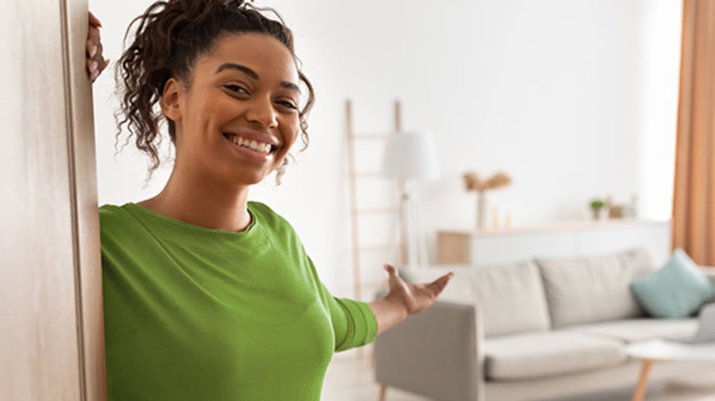 Woman inviting us into her rented or bought home