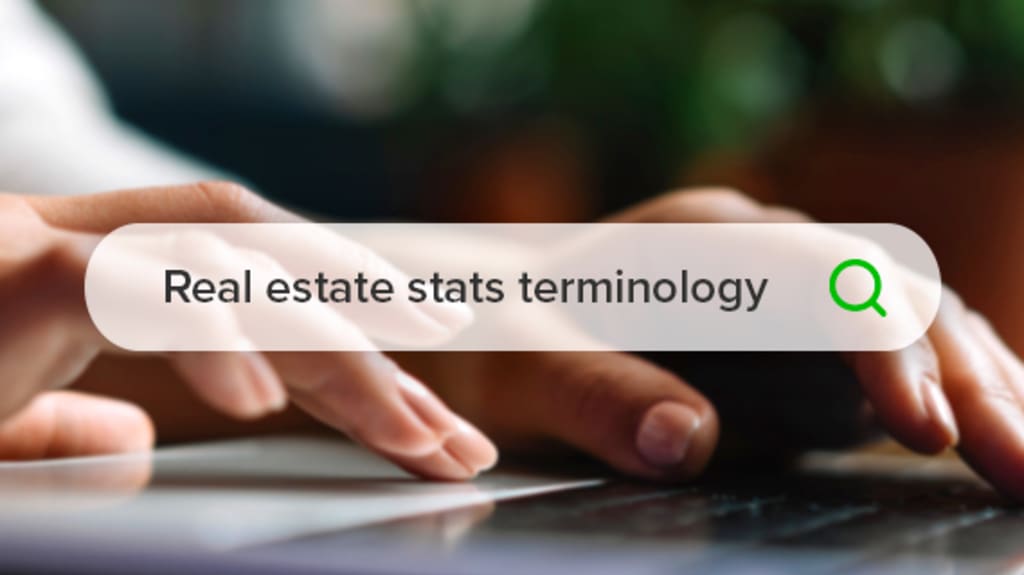 Woman searching "Real estate stats terminology" on a computer