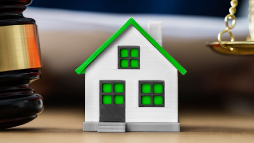 Miniature house with gavel and justice scale