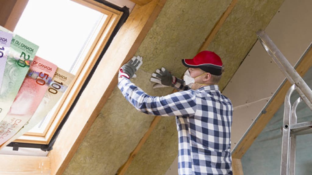 Men doing home renovations and hand holding Canadian money
