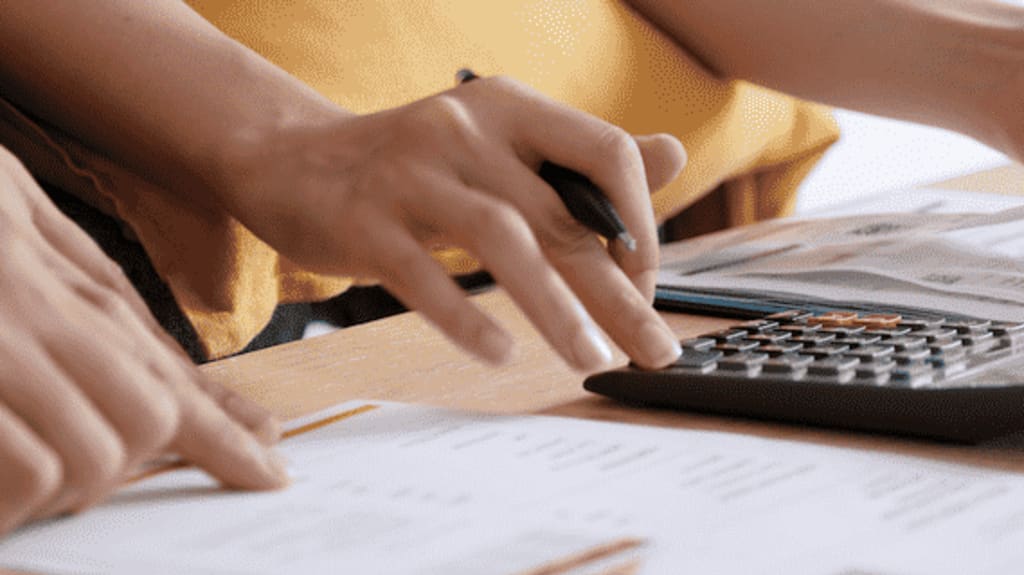 Person calculating expenses for buying a house