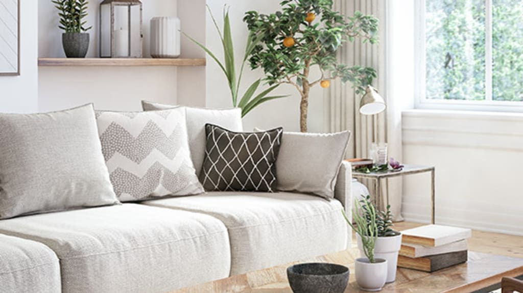 Beautiful classic-style living room with a cream sofa, open shelves, long curtains, and a decorative light fixture in a warm ambiance for a visit