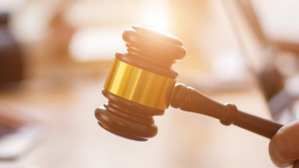 Wooden gavel held by a hand