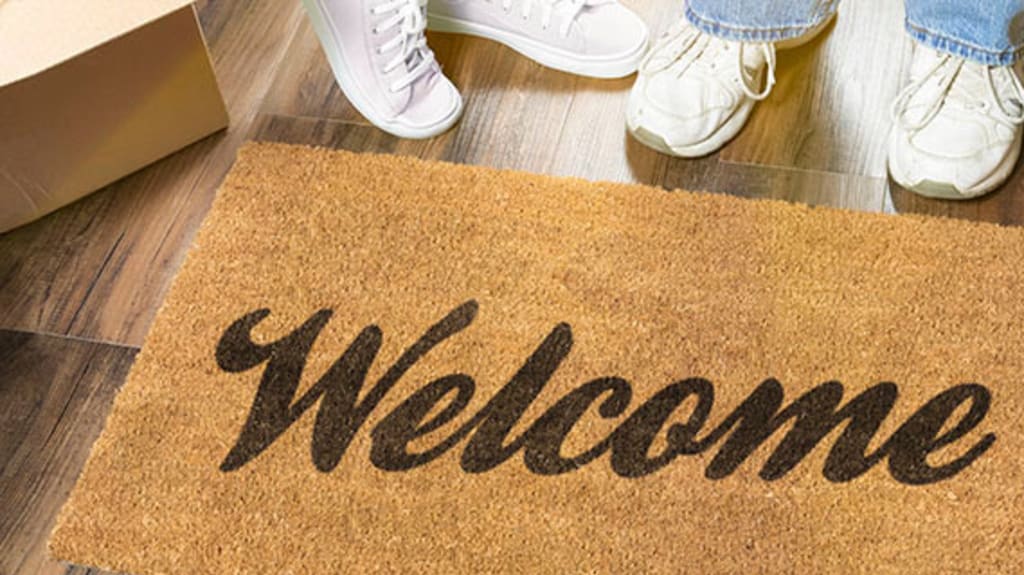 Welcome mat with couple just moved in