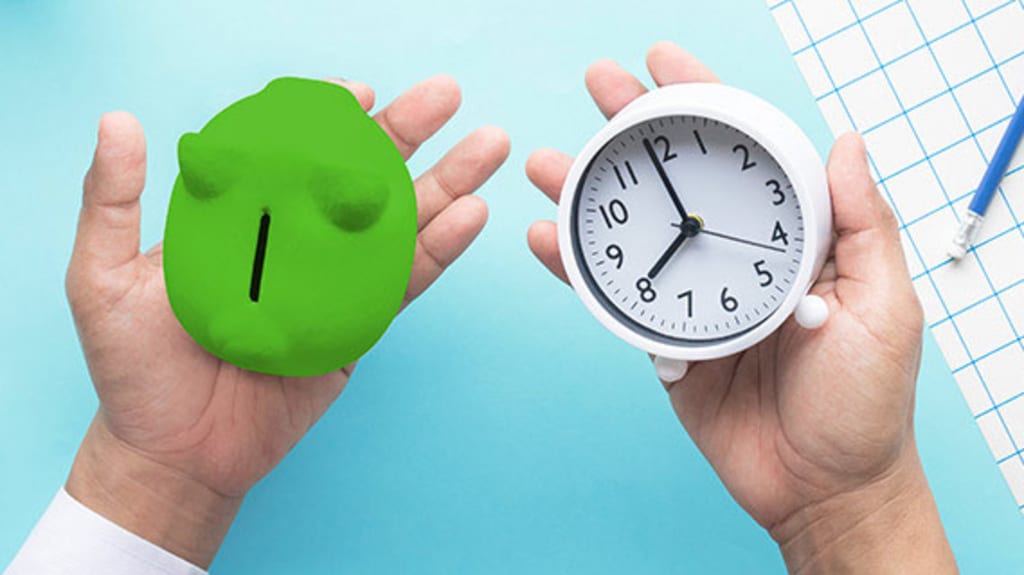 Hands holding a piggy bank and a clock