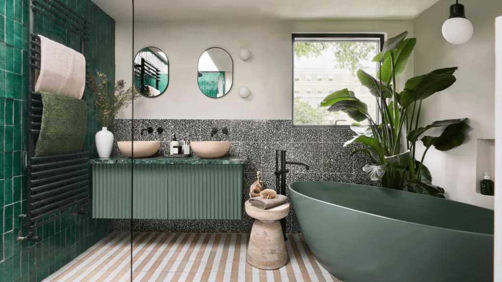 Trendy bathroom with green accents and indoor plant 
