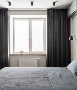Opaque curtains that add height to a bedroom