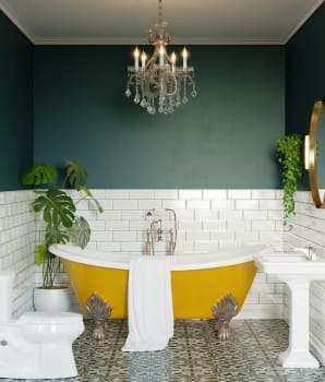 Retro bathroom with dark green wall, orange bathtub, plants and vintage chandelier 