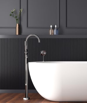 White bathtub in a black bathroom with ribbed facade 