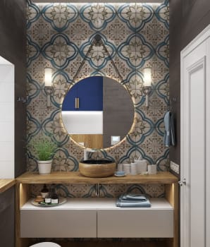 Bathroom with patterned ceramic wall tiles and round mirror 