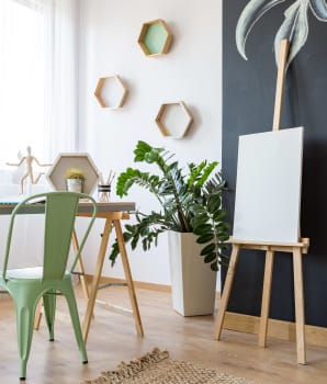 Chalkboard wall, canvases, easel and desk area