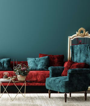 Interior with red sofa, table and decoration in a blue-green living room