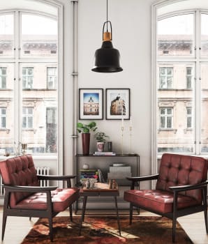 Large windows, leather chairs, coffee tables and other old-fashioned accessories in a home