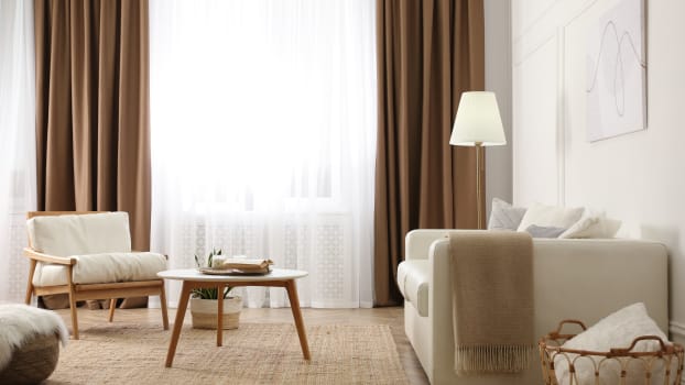Brown curtains in a beige-coloured living room