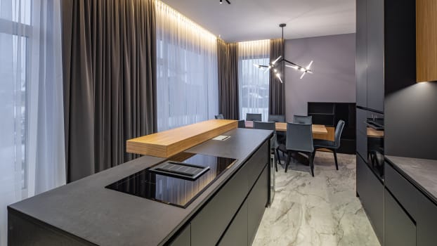 Large curtain panels in a dark-coloured kitchen