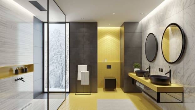 Bathroom with yellow, grey and marble tiles, black metal shelving and walk-in shower 