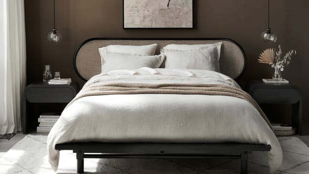 Cozy bed with blankets in earthy tones