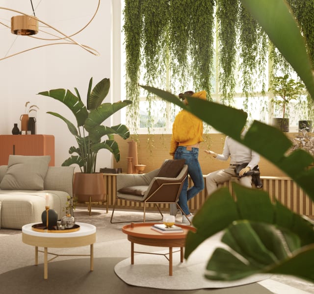 Coworking space with two persons chatting near a sofa.