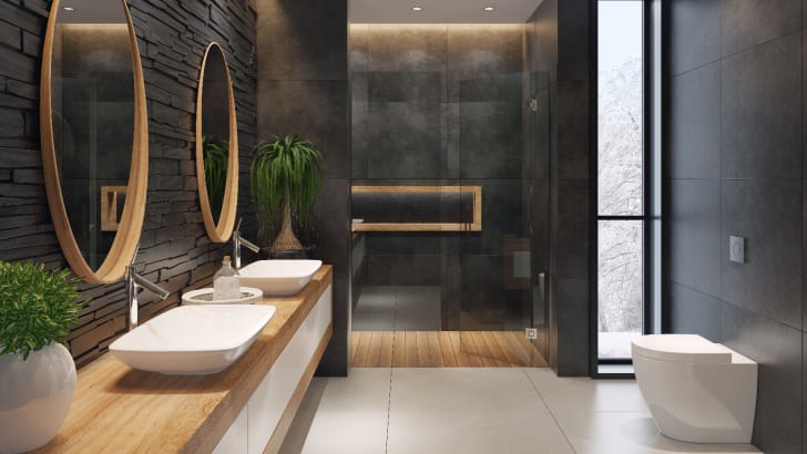 Modern black bathroom with long wooden vanity and white basins