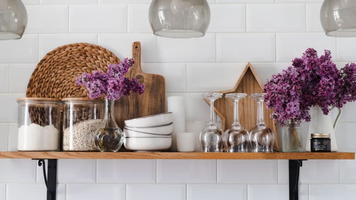 Shelf on white tiled kitchen wall