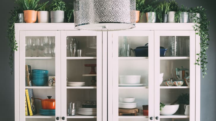 White display cabinets with assorted cookware and glasses