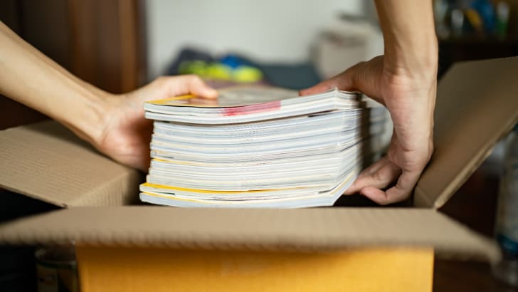 Person packing magazines into a box