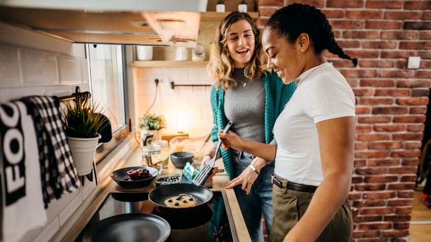 Two girls cooking in an apartment
