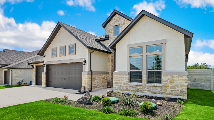 Single-family home with double garage, stone facade and landscaped front yard