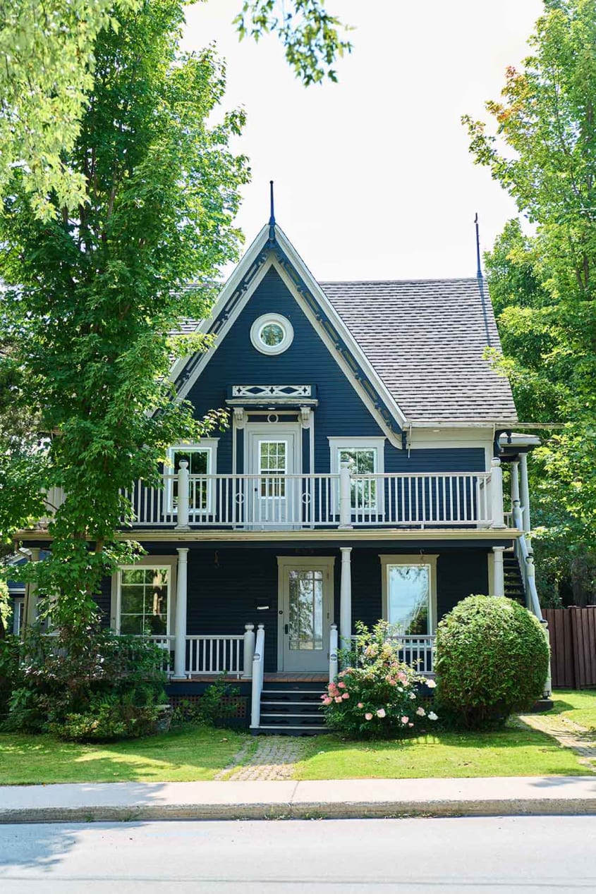Blue Victorian house with pointed roof in Sherbrooke