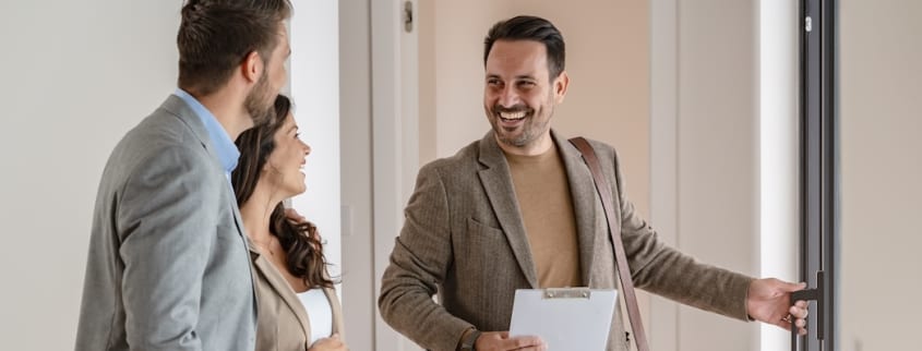 Un propriétaire fait visiter son appartement à un couple de locataires potentiels
