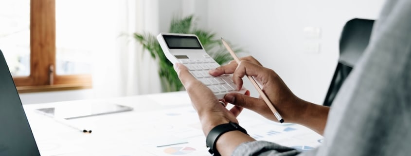 A woman calculates how much tax she'll have to pay when she sells her property