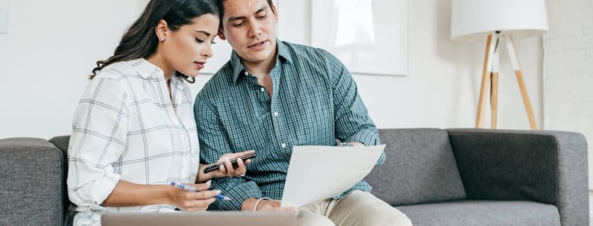 A man and a woman look at a preliminary contract