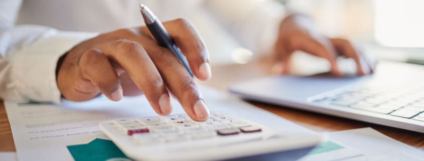 Hand clicking on a calculator