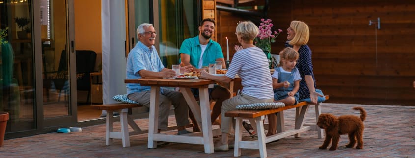 Family eating around a table on a terrace