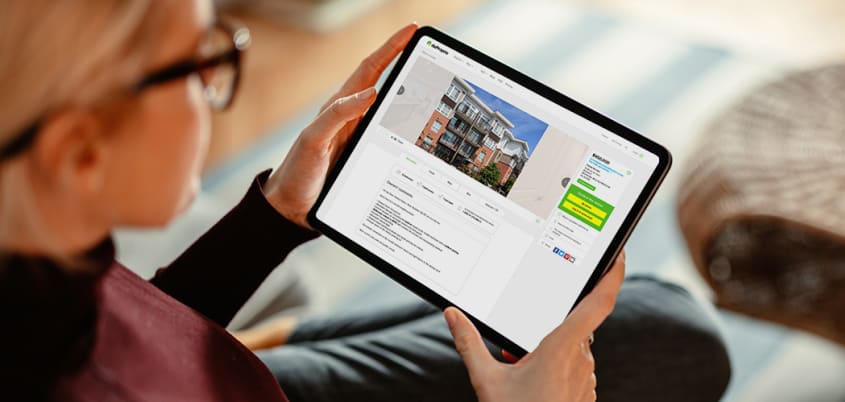 Woman looking at a DuProprio listing on her tablet