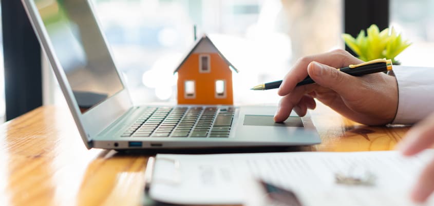Man calculating whether to buy or rent a property