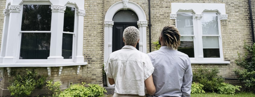 Couple in front of a foreclosure house