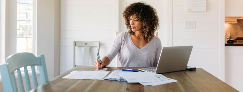Woman doing her taxes at home