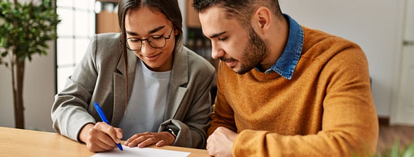 Couple signing a new mortgage contract