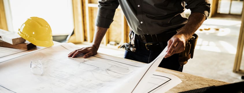 Contractor looking over plans for new build