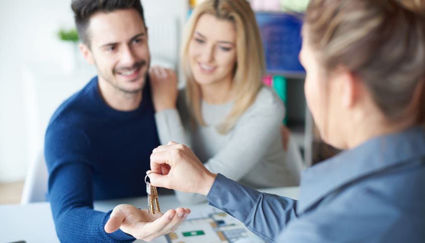 Notary giving house keys to a couple