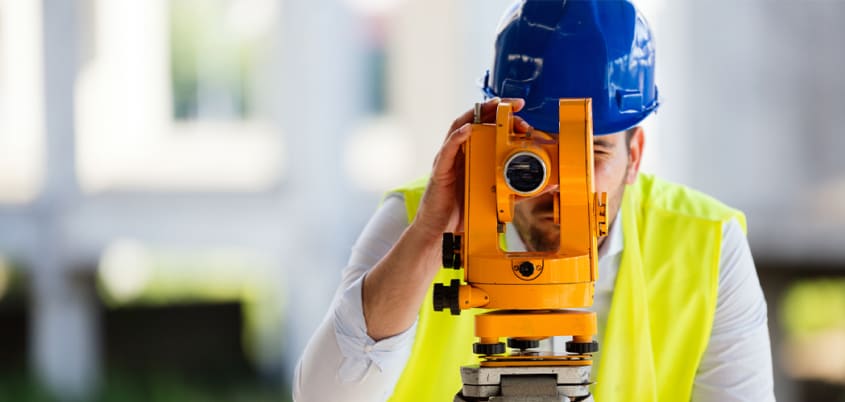 Land surveyor taking a measurement